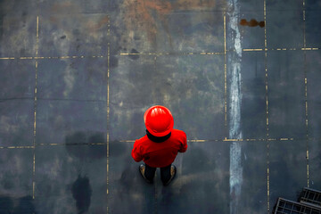 Aerial View of Worker in Red on Industrial Floor