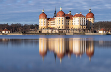 Moritzburg - a fairytale castle reflected on the lake on a sunny day