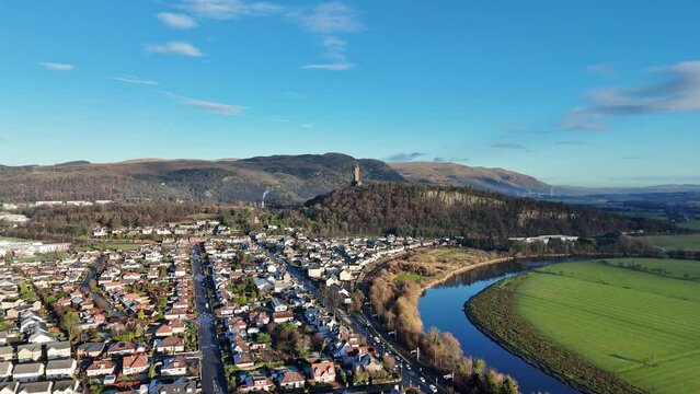 Aerial footage of Cornton district with the National Wallace Monument in distance, Scotland, UK