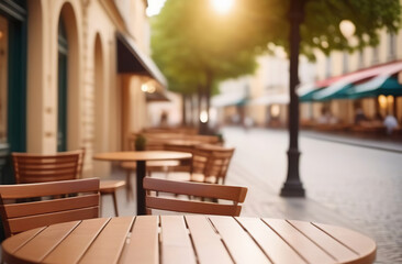 Empty wooden table and blurred background of city restaurant, coffee shop for display of montage product. Bokeh effect. Scene round wood tabletop counter on blur cafe, bar. Banner. Outdoors, outside. - obrazy, fototapety, plakaty