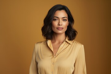 Portrait of beautiful asian woman in yellow shirt on brown background