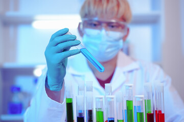 Asian middle-aged male scientist conducts research in a laboratory, surrounded by petri dishes and...