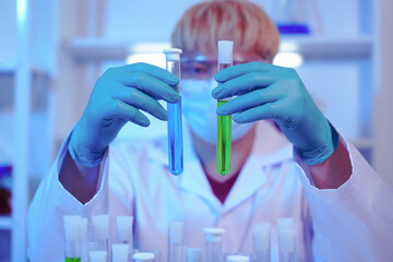 Asian middle-aged male scientist conducts research in a laboratory, surrounded by petri dishes and...
