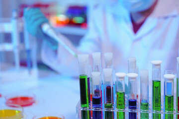 Asian middle-aged male scientist conducts research in a laboratory, surrounded by petri dishes and...