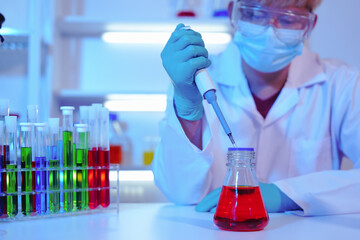 Asian middle-aged male scientist conducts research in a laboratory, surrounded by petri dishes and...