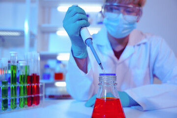 Asian middle-aged male scientist conducts research in a laboratory, surrounded by petri dishes and...