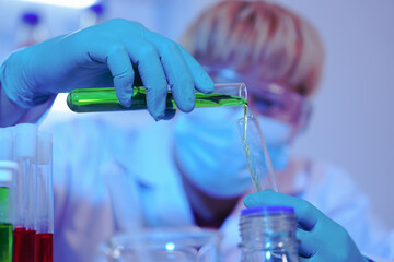 Asian middle-aged male scientist conducts research in a laboratory, surrounded by petri dishes and...