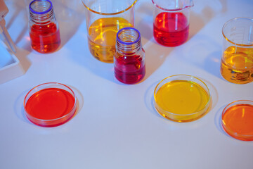 Asian female scientist passionately conducts experiments in a laboratory, surrounded by petri...
