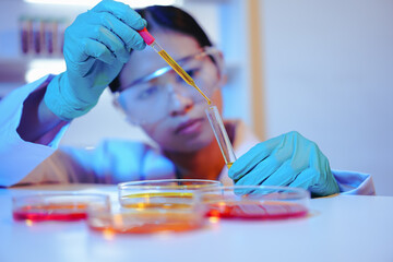 Asian female scientist passionately conducts experiments in a laboratory, surrounded by petri...