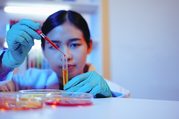 Asian female scientist passionately conducts experiments in a laboratory, surrounded by petri...