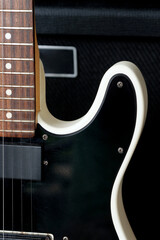 Electric guitar on the background of the guitar amplifier. Close-up.