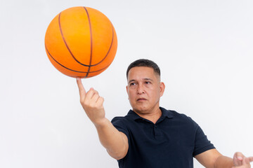 A skilled retired basketball player shows a nice trick, spinning the ball on his index finger....