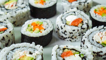 Huge Sushi Roll Platter on wood background. Salmon sushi set, serving food for restaurant, menu, advert or package, close up, selective focus