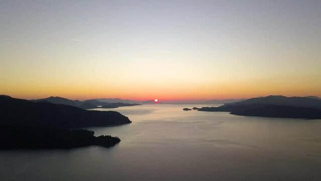 Capturing Sunset's Majesty: Breathtaking Vertical Drone Video as Sun Dips Below Horizon