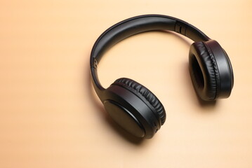 wireless headphones for listening to music on an orange background