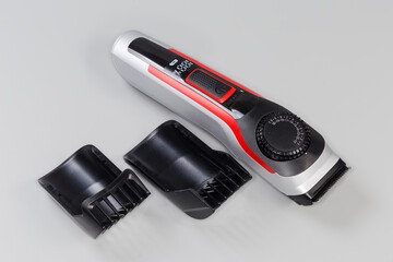 Electric rechargeable hair trimmer and two replaceable nozzles