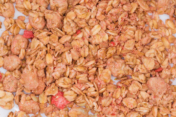 Dry muesli with dried fruits on dish, top view