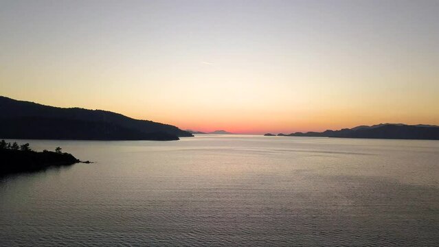 Capturing Sunset's Majesty: Breathtaking Vertical Drone Video as Sun Dips Below Horizon