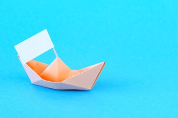 Paper Boat with flag. paper ship on background.