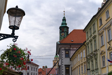 Sightseeing at the old town of City of Ljubljana with alley, church tower and lantern on a cloudy...