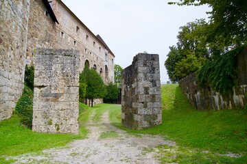 Looking up stone wall and tower of Castle of Ljubljana on a cloudy summer day. Photo taken August...