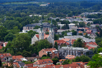 Fototapeta premium Aerial view of City of Ljubljana seen from Sance castle hill with mountain panorama in the background on a cloudy summer day. Photo taken August 9th, 2023, Ljubljana, Slovenia.