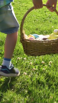 Two children boy and girl having easter egg hunt in garden backyard