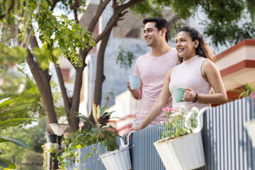 Couple spending leisure time together while drinking coffee outdoors