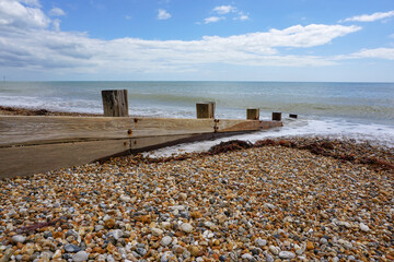 Coastal view looking out to sea from traditional English beach. Stone pebble beach landscape 