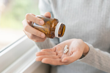 Dietary supplement or sick, asian young woman, girl hold pills, drugs medical tablet on hand...