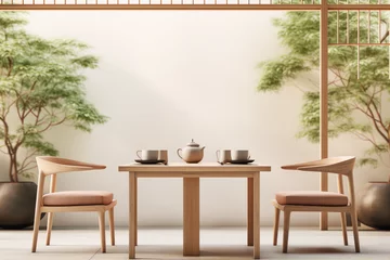 Fotobehang Two wooden chairs and a table with a teapot and teacups in a Zen garden. © kamel