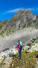 Hiker woman at alpine lake Grünecker See with scenic view of majestic mount Roemerspitz in High...