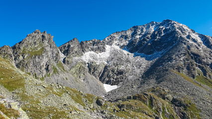Fototapeta na wymiar Panoramic view of majestic mountain peak Schoenbretterkogel in High Tauern National Park, Carinthia, Austria. Idyllic hiking trail in Austrian Alps. Wanderlust paradise Mallnitz. Rough alpine terrain.
