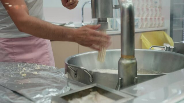 Fresh churro productions. Street food vendor prepares churros into a machine. Churro is Spanish traditional donut.