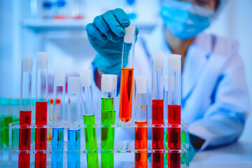 Female scientist diligently conducts virus blood lab tests, contributing to critical research and...
