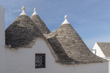 Trulli roofs against a blue sky. Alberobello, Apulia, Italy