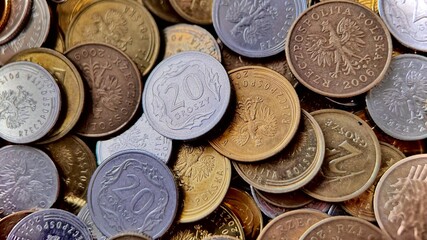 A bunch of Polish coins of different denominations. Background of coins, inflation theme, economics.