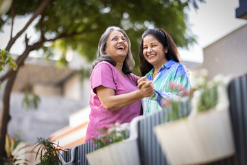 Two cheerful senior female spending leisure time together at outdoor.