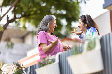 Two cheerful senior female spending leisure time together at outdoor.