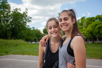 Obraz premium Female couple hug after basketball game