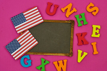 usa flag card with frame photo and alphabets on pink background. Concept of English language courses