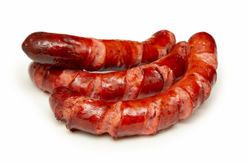 three cooked pork sausages isolated