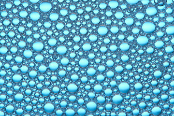 Abstract blue macro background with lots of soap bubbles.