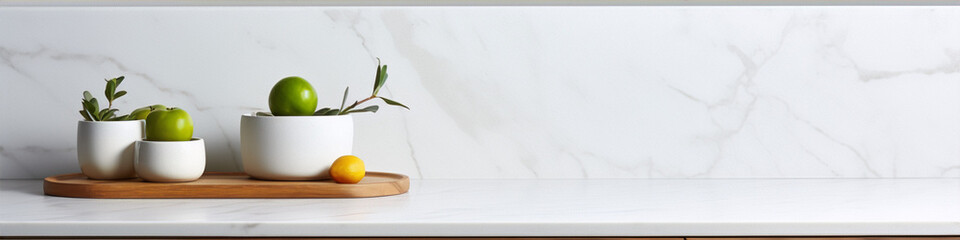 Two potted green apples and a lemon on a wooden tray on a marble table.