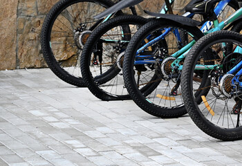 An old bike that has back flat tire parked by the urban road in the evening of the day and waited...