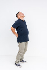 Full body photo of a middle aged asian man suffering from chronic lower back pain, stemming from years of poor posture. Isolated on a white background.
