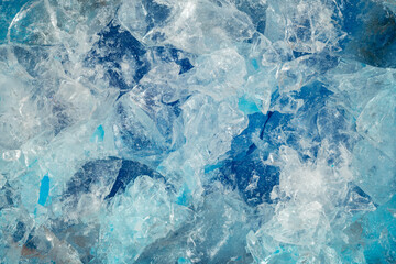 Fototapeta na wymiar Blue ice surface with cracks background texture. close-up frozen water. broken ice.