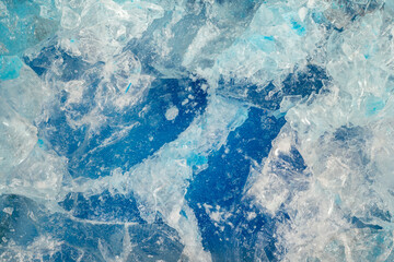 Blue ice surface with cracks background texture. close-up frozen water. broken ice.