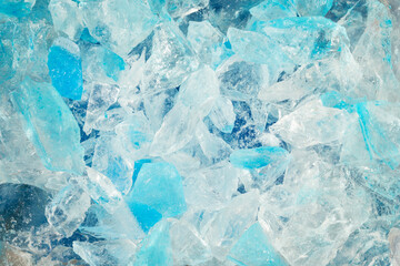 broken ice close up. pieces of crushed blue ice cracks background texture. close-up frozen water.