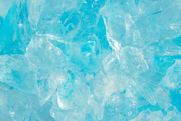 broken ice close up. pieces of crushed blue ice cracks background texture. close-up frozen water.